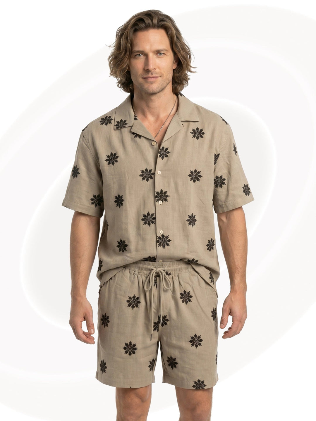 Man wearing a beige shirt and shorts set with black snowflake pattern on a white background