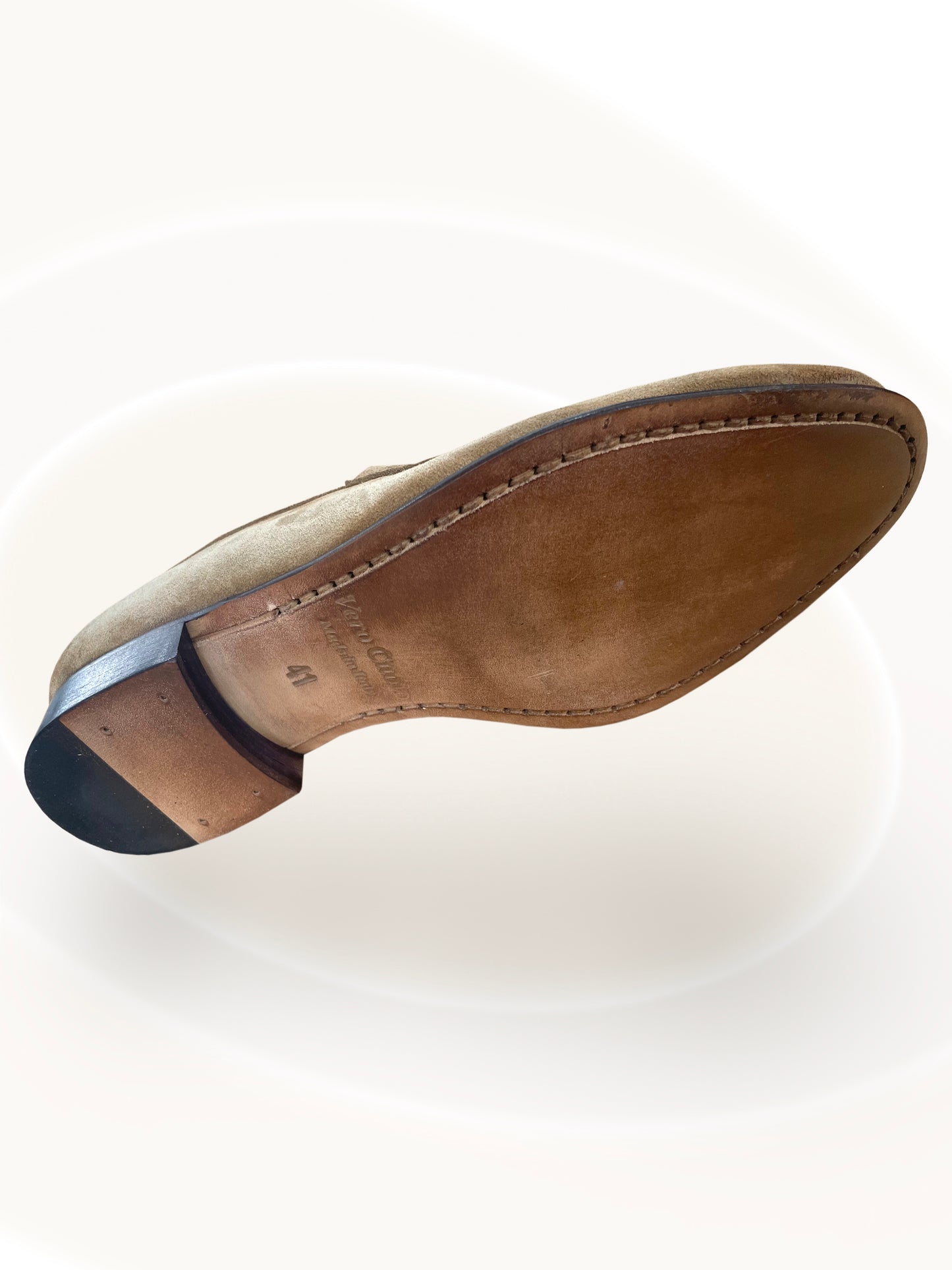 Close-up of a brown leather shoe sole on a white background
