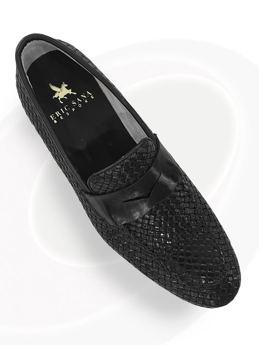 Black woven loafer shoe on a white background