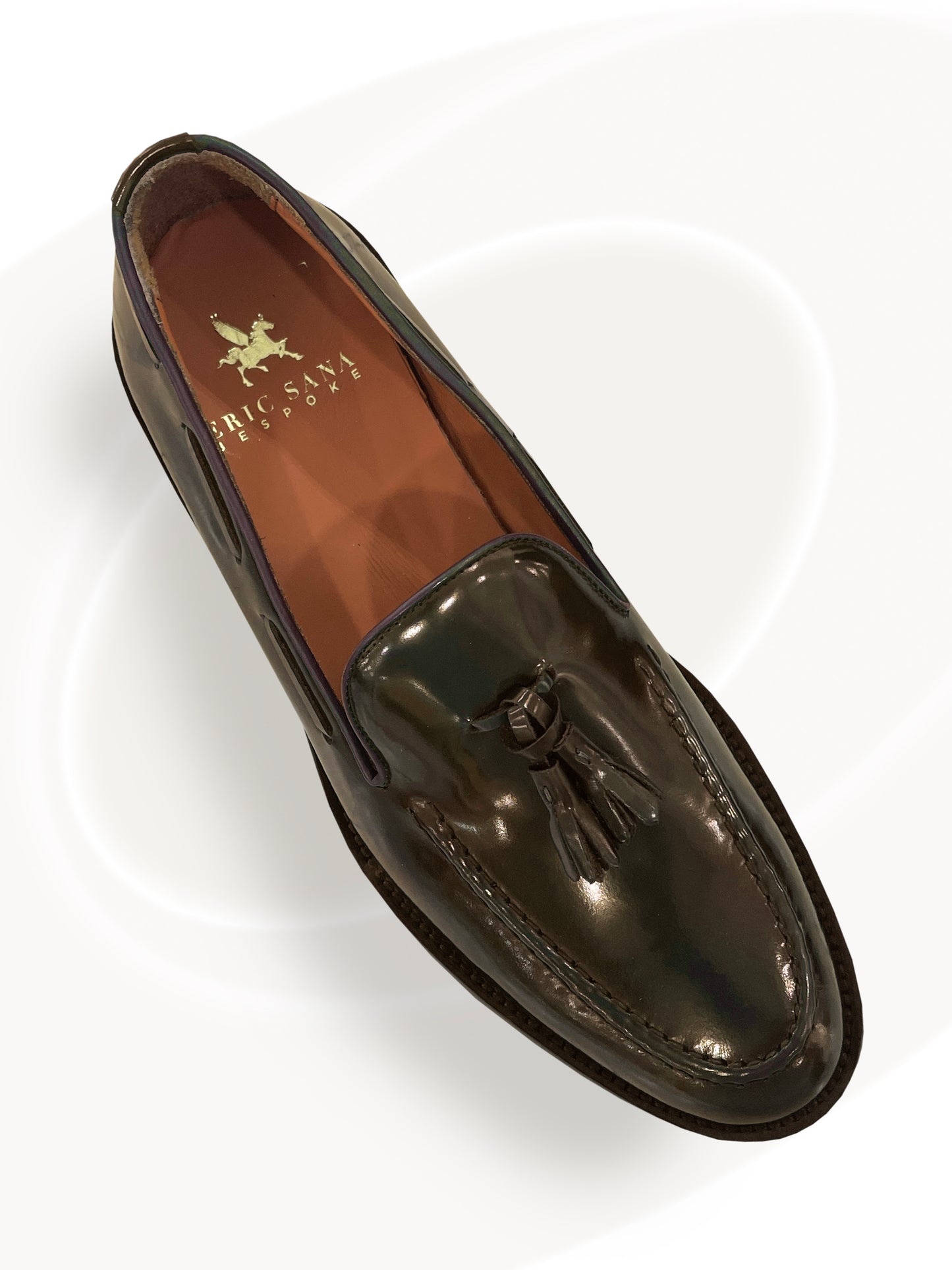 Shiny black loafer shoe on a white background