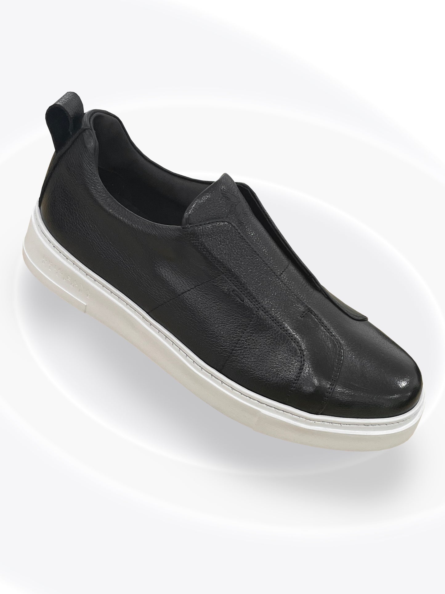 Black slip-on sneaker on a white background