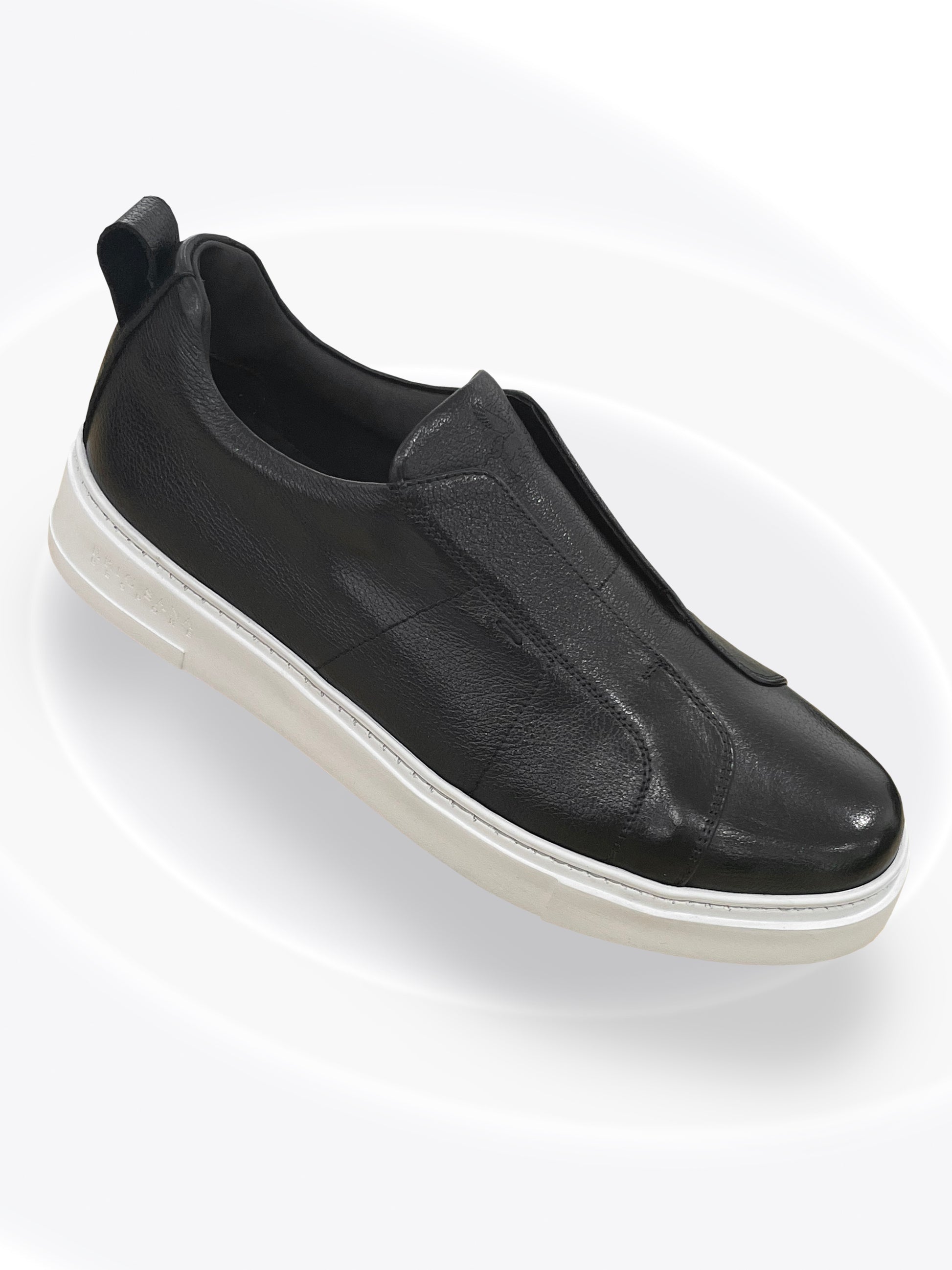 Black slip-on sneaker on a white background