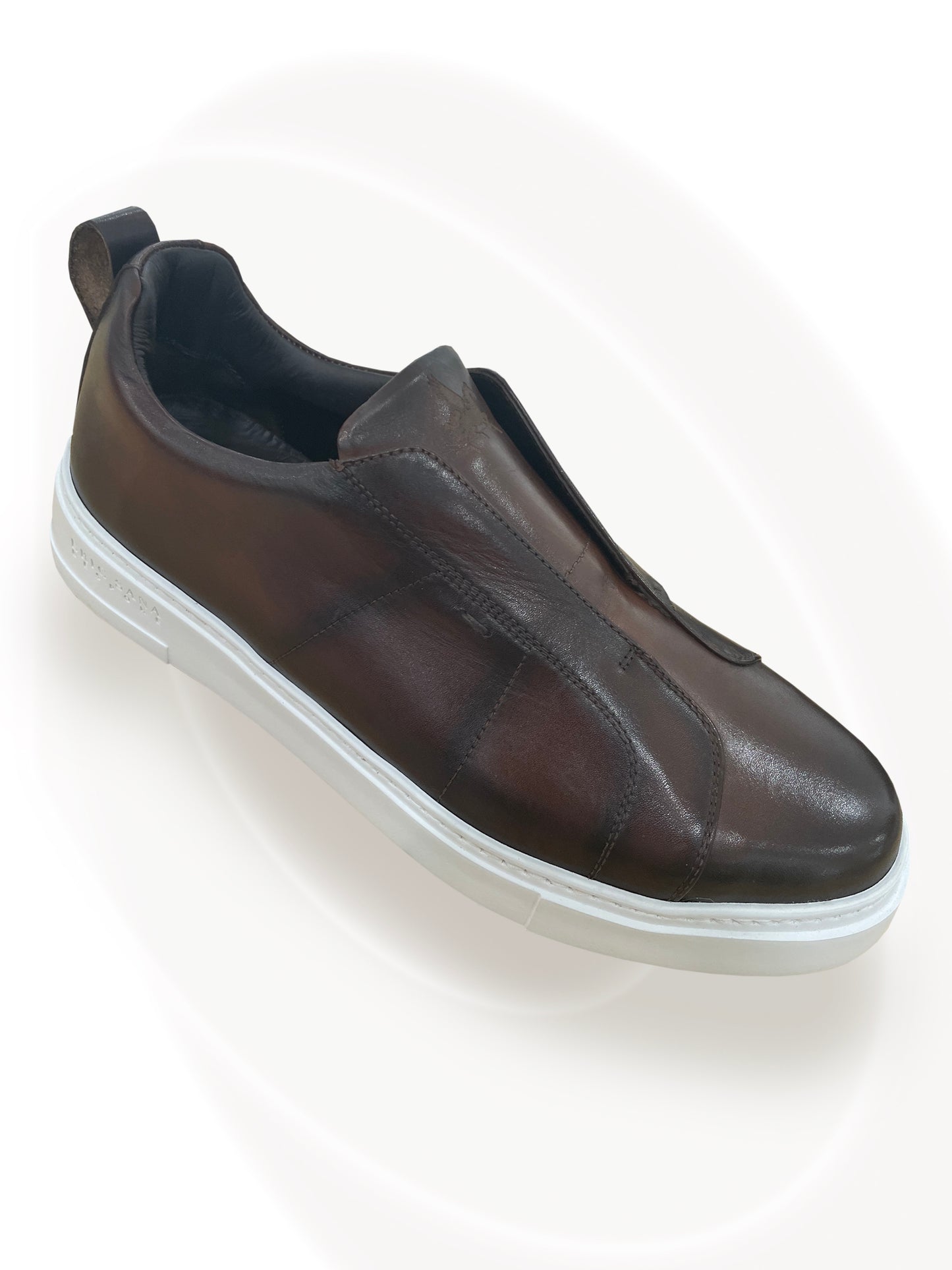 Brown slip-on shoe on a white background