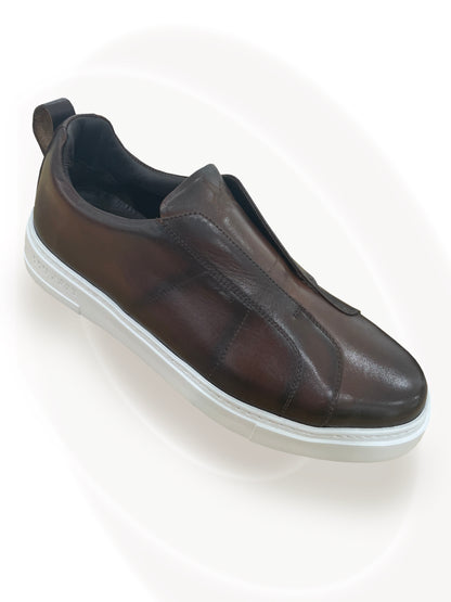 Brown slip-on shoe on a white background