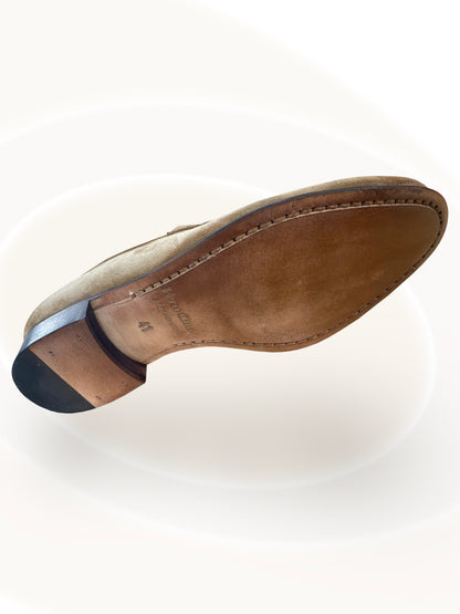 Close-up of a brown leather shoe sole on a white background