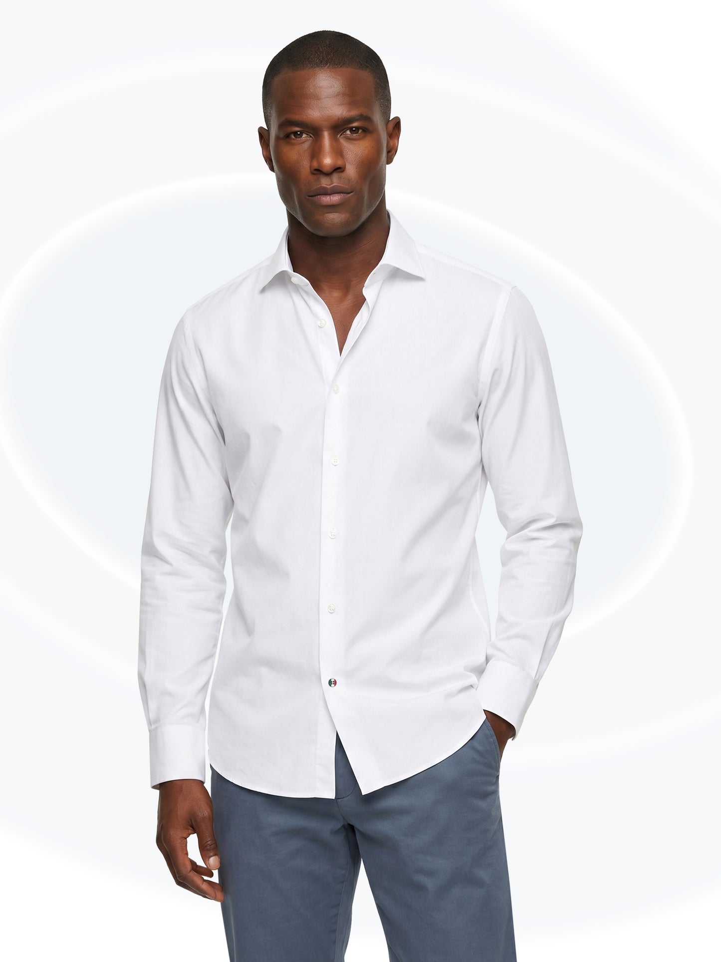 Man wearing a white dress shirt and gray pants on a white background