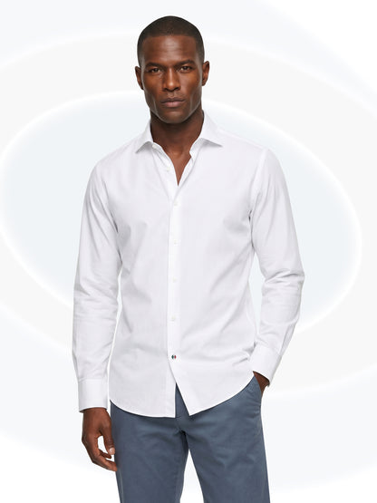 Man wearing a white dress shirt and gray pants on a white background
