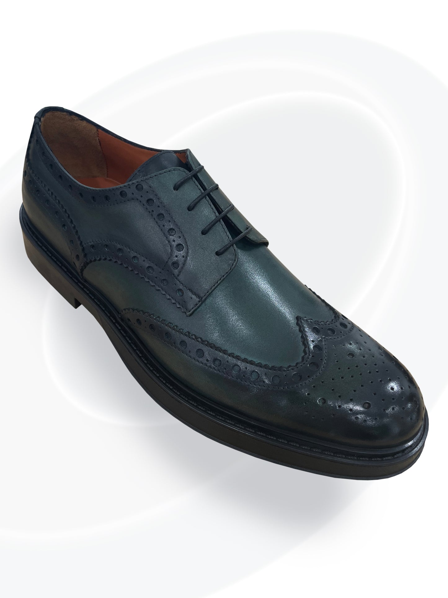 green leather dress shoe on a white background