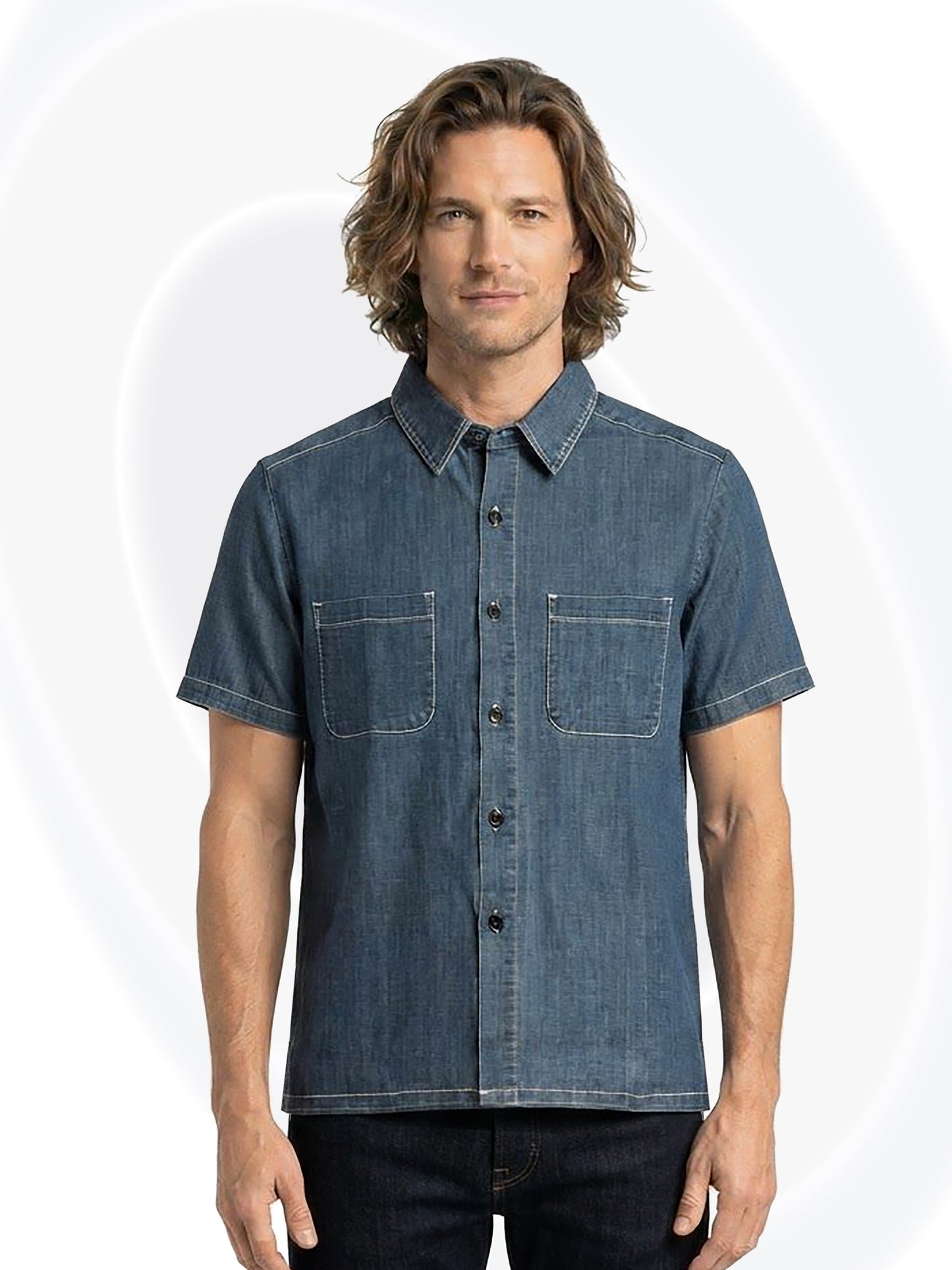 A man wearing a short-sleeve button-up denim shirt with two chest pockets, shown against a light gray background with subtle circular patterns.