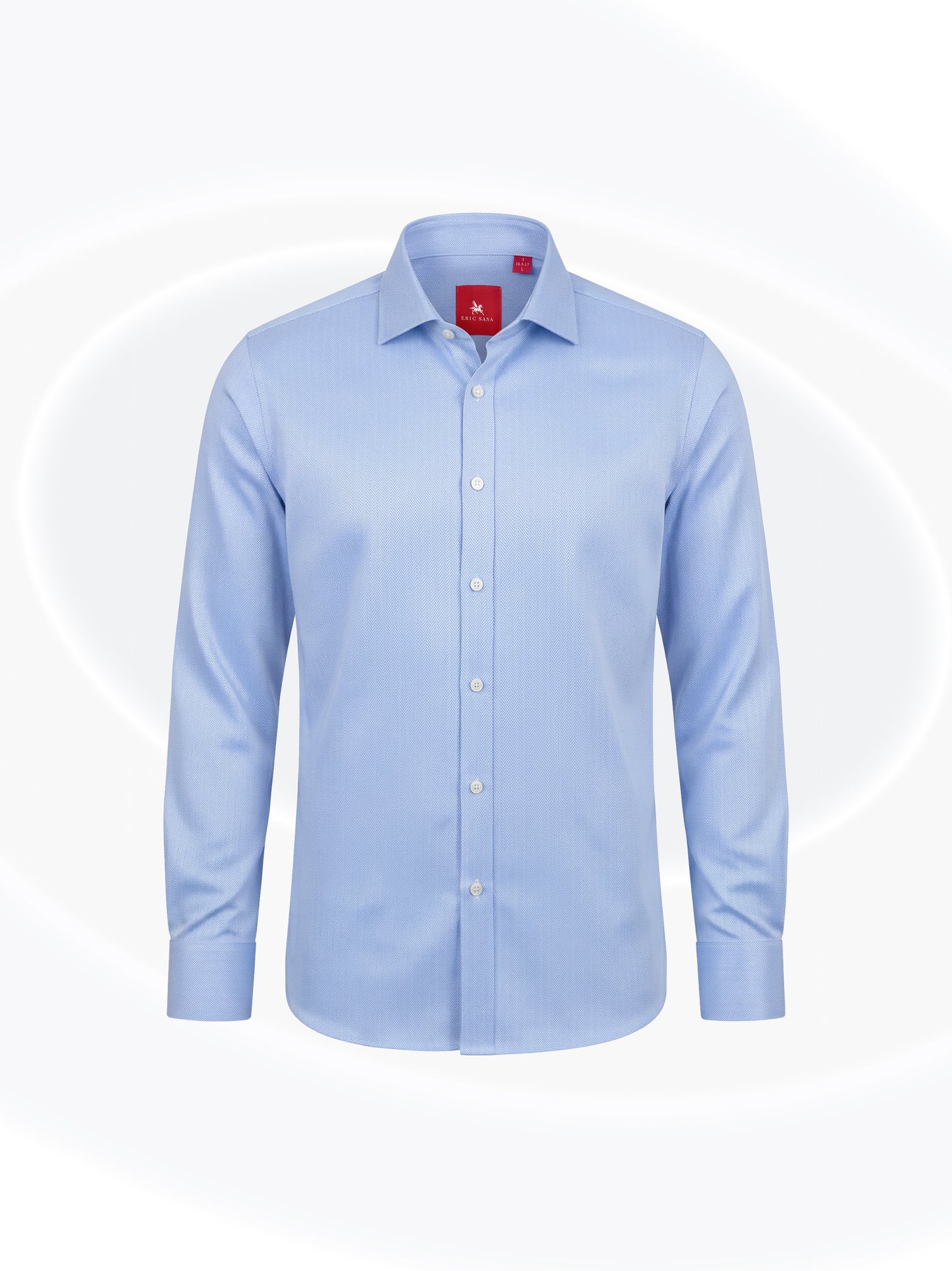 Sky blue herringbone long-sleeve button-down Essential Shirt with a classic collar and red Eric Sana label, displayed on a white background.