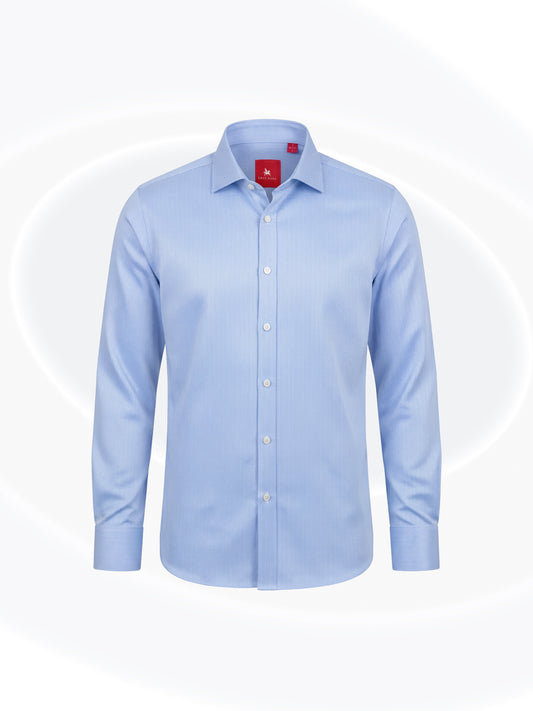A light blue long-sleeve button-down dress shirt with a classic collar, displayed on a clean white background with subtle circular graphic elements.