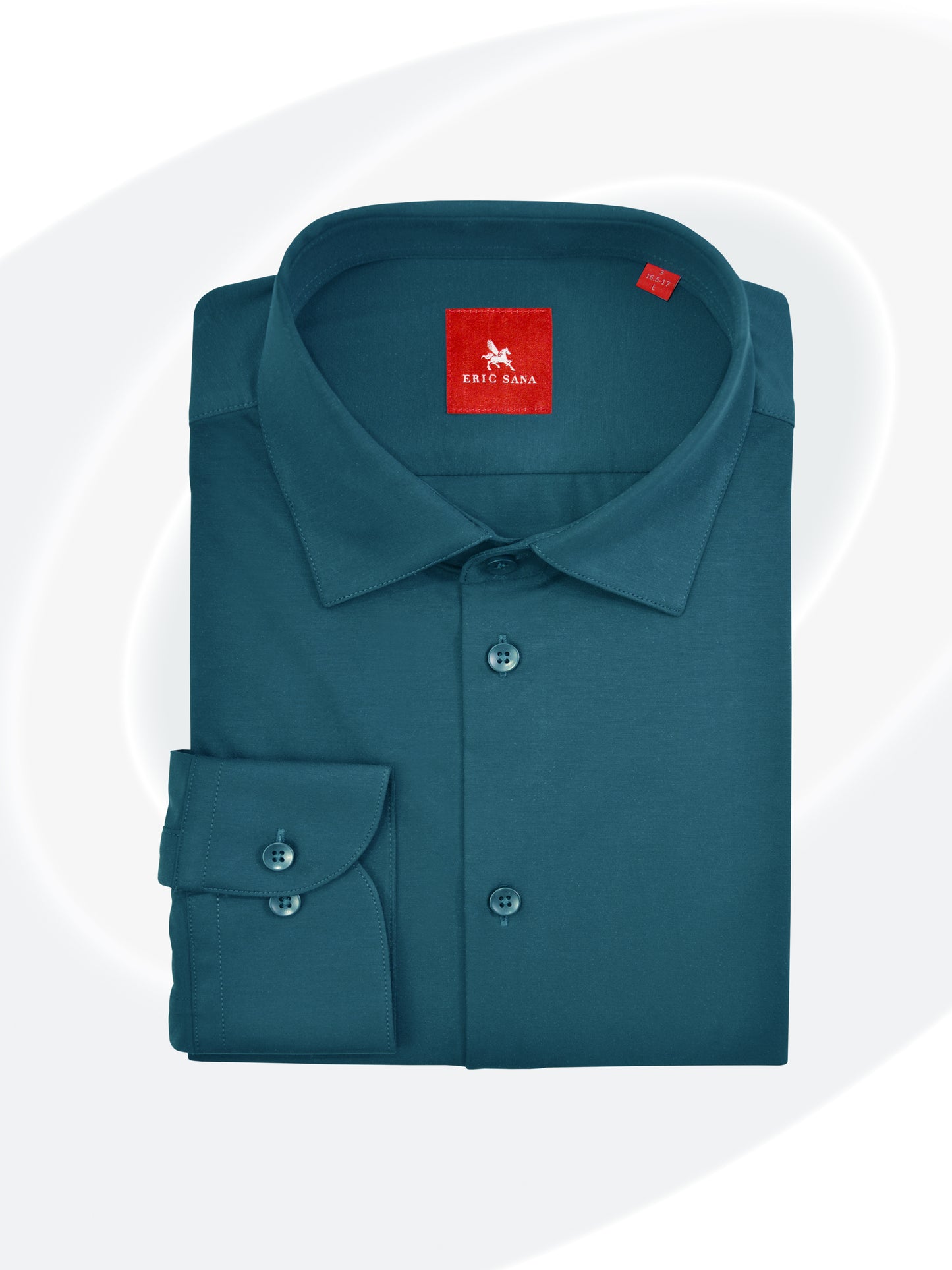 Shelby green long-sleeve dress shirt neatly folded with a red Eric Sana logo label, displayed on a white background — Essential Shirt.