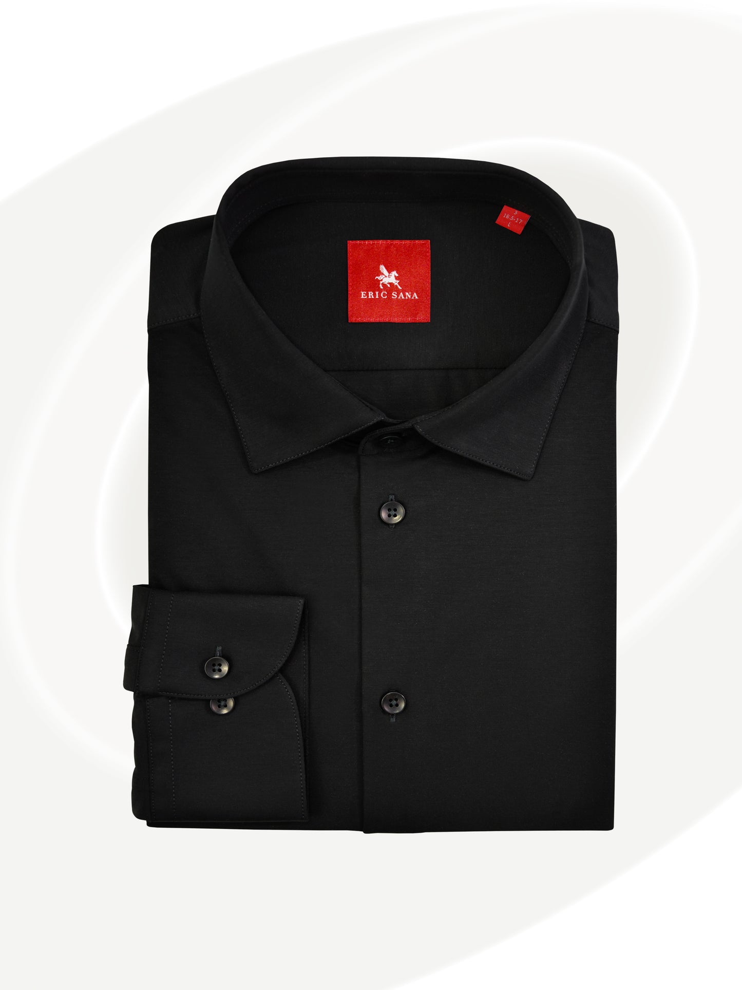 Black long-sleeve dress shirt neatly folded with a red Eric Sana logo label, displayed on a white background — Essential Shirt.