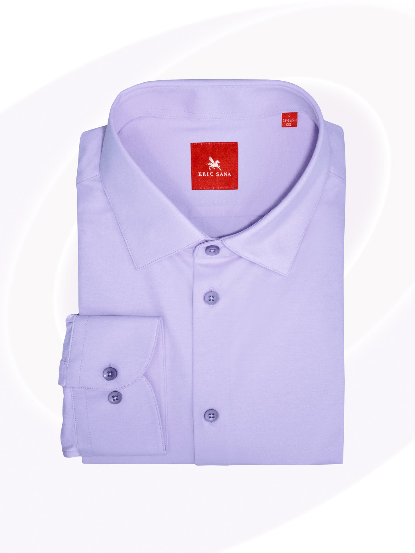 Violet long-sleeve dress shirt neatly folded with a red Eric Sana logo label, displayed on a white background — Essential Shirt.
