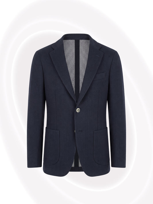 A dark navy blue blazer with notched lapels, two front buttons, and front patch pockets, shown against a light gray background with subtle white curved lines.
