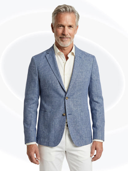 Man wearing a blue blazer over a white shirt and white pantson a white background