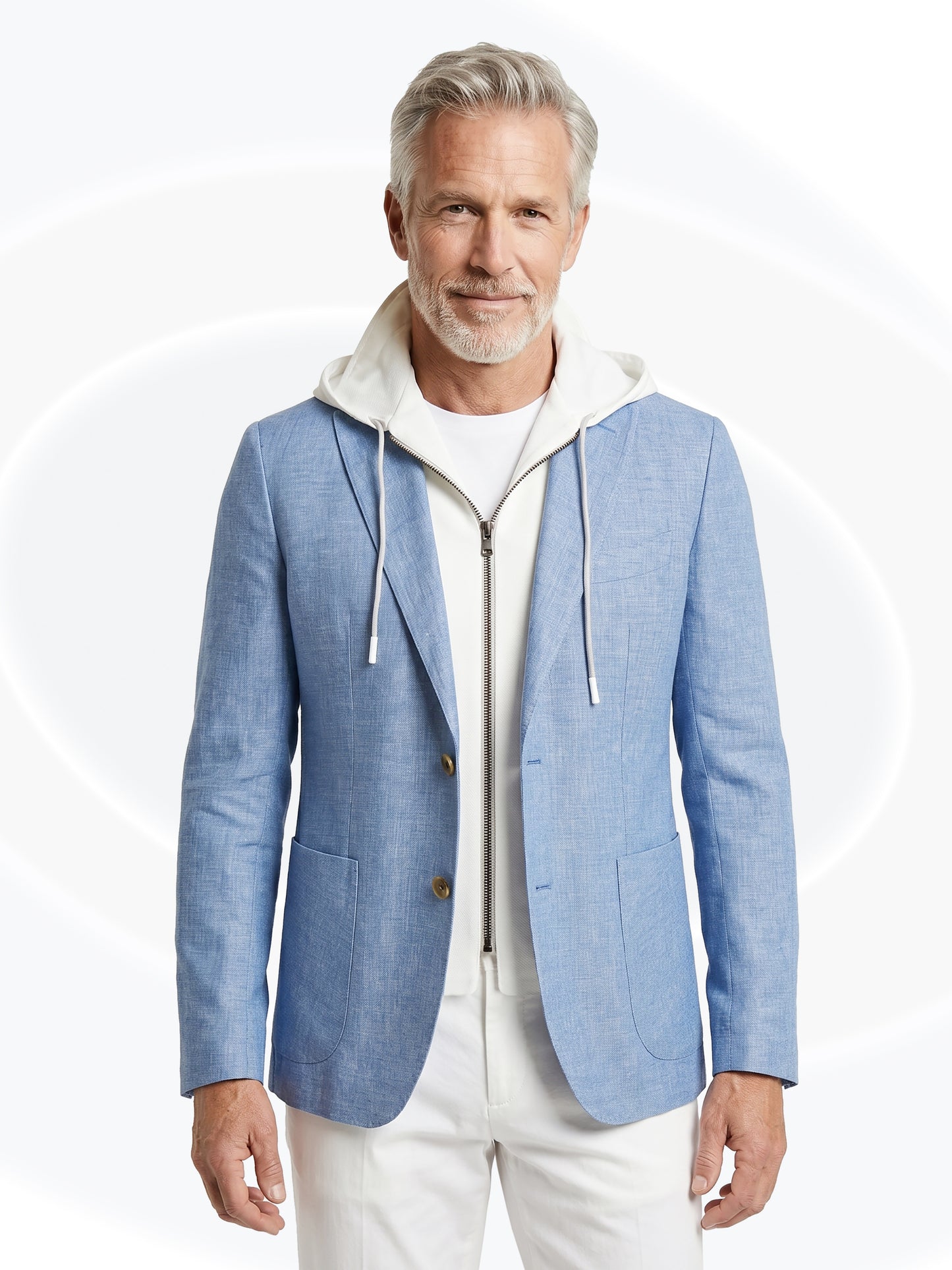 Man wearing a light blue blazer over a white hoodie on a white background