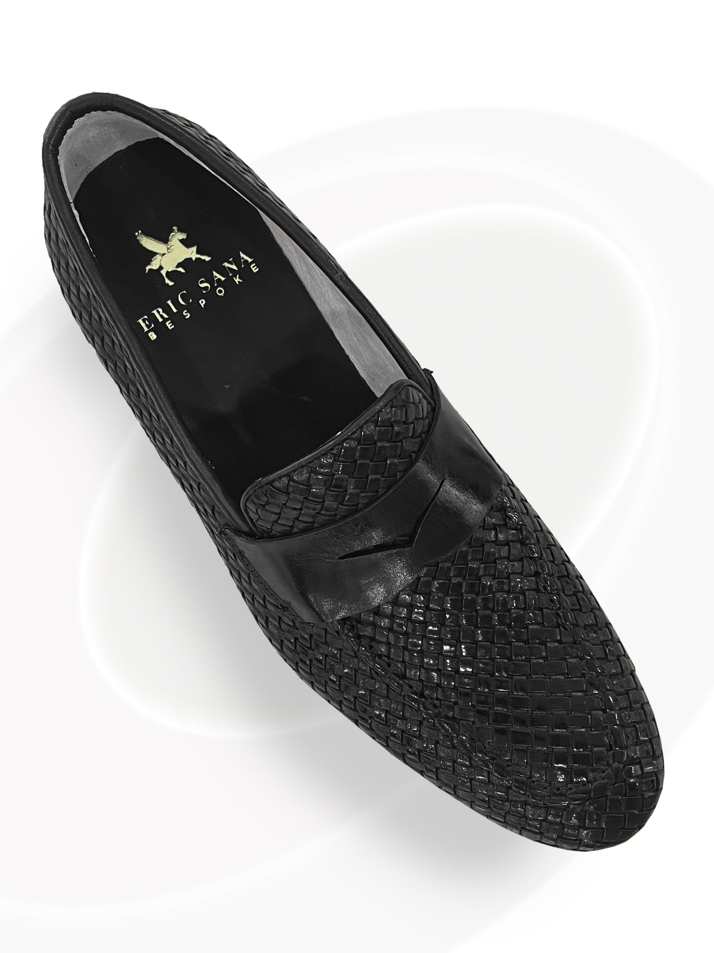 Black woven loafer shoe on a white background