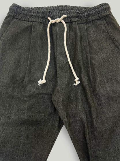 Military green pants with a drawstring on a light gray background