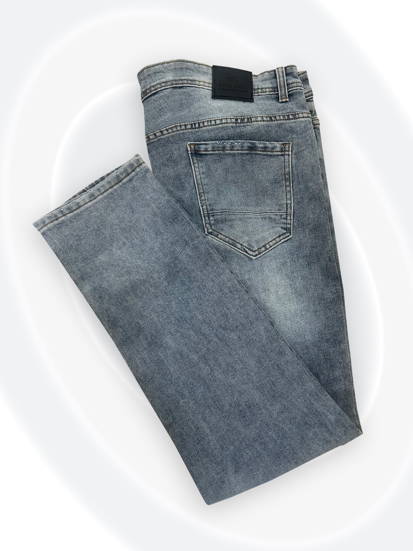 Folded blue jeans on a white background
