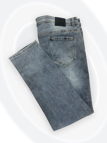 Folded blue jeans on a white background