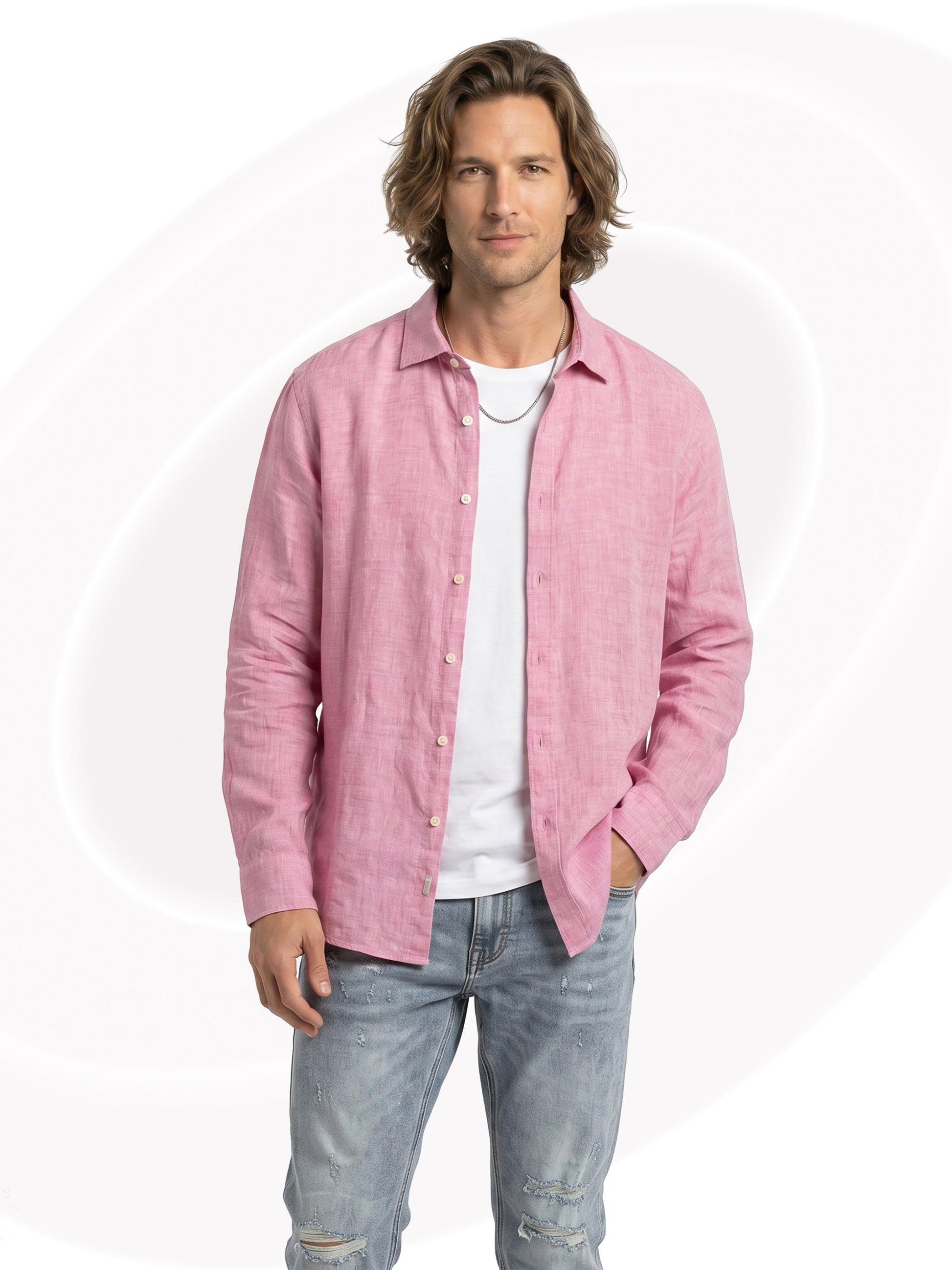 Man wearing a pink linen shirt over a white t-shirt and light blue jeans on a white background