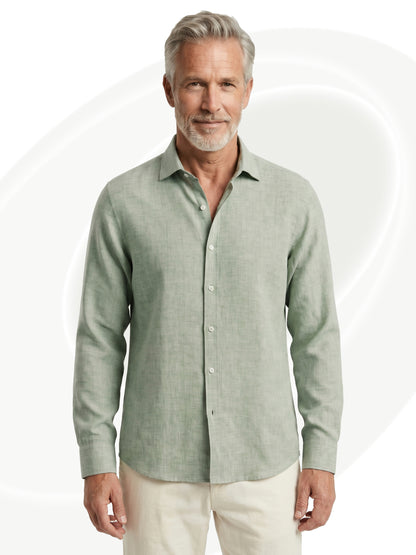 Man wearing a light green linen shirt on a white background