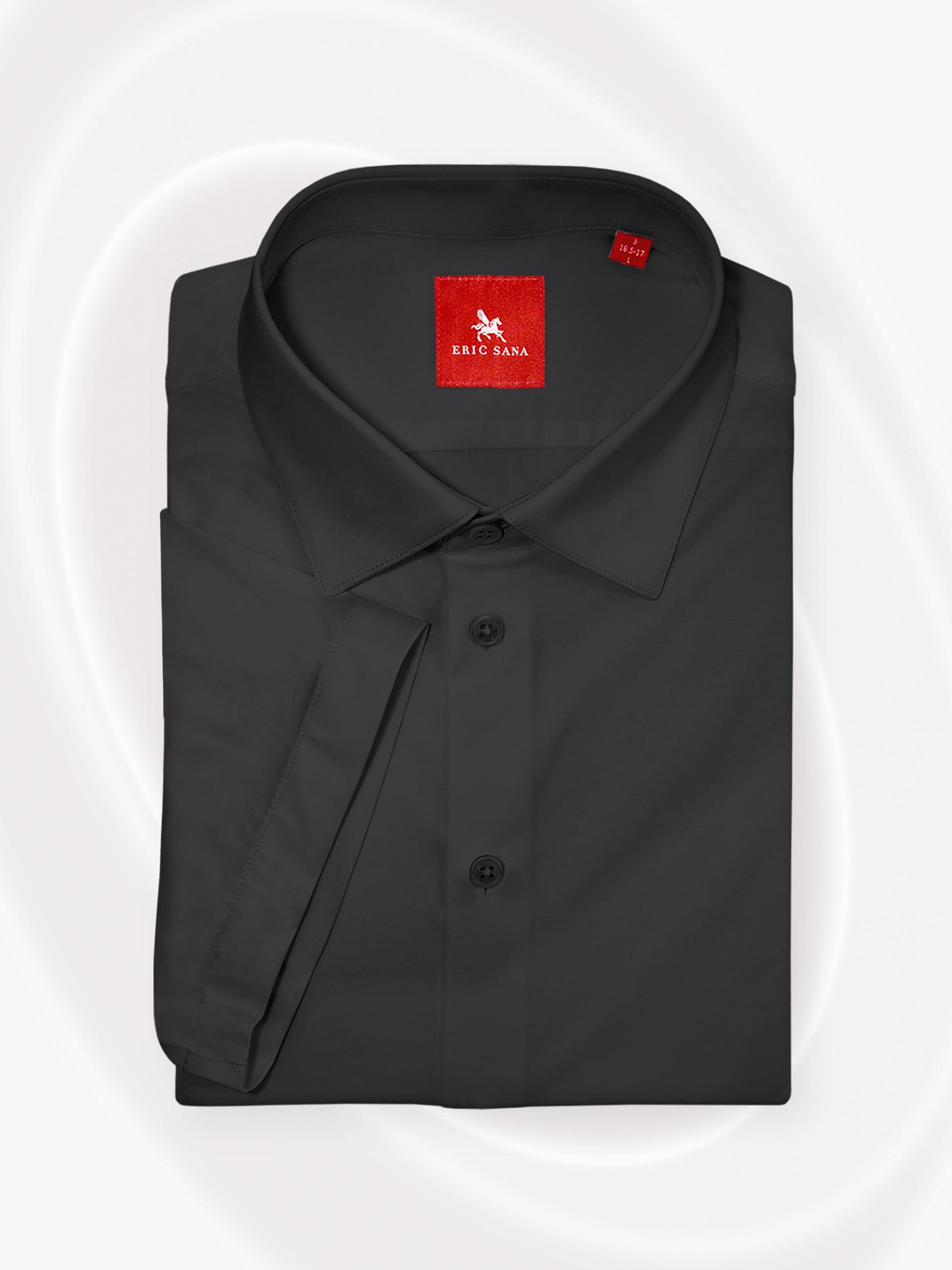 Black short-sleeve dress shirt neatly folded with a red Eric Sana logo label, displayed on a white background — Essential Shirt.