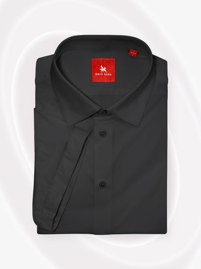 Black short-sleeve dress shirt neatly folded with a red Eric Sana logo label, displayed on a white background — Essential Shirt.