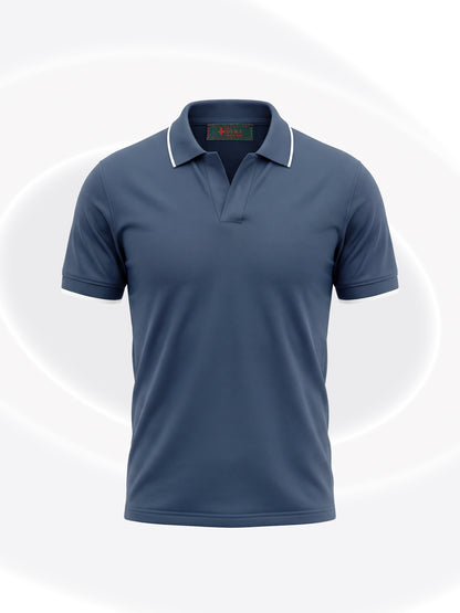 A short-sleeve polo shirt in slate blue with a white contrast collar, shown on a light gray background with subtle white circular patterns.