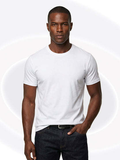 Man wearing a plain white t-shirt and dark jeans on a white background